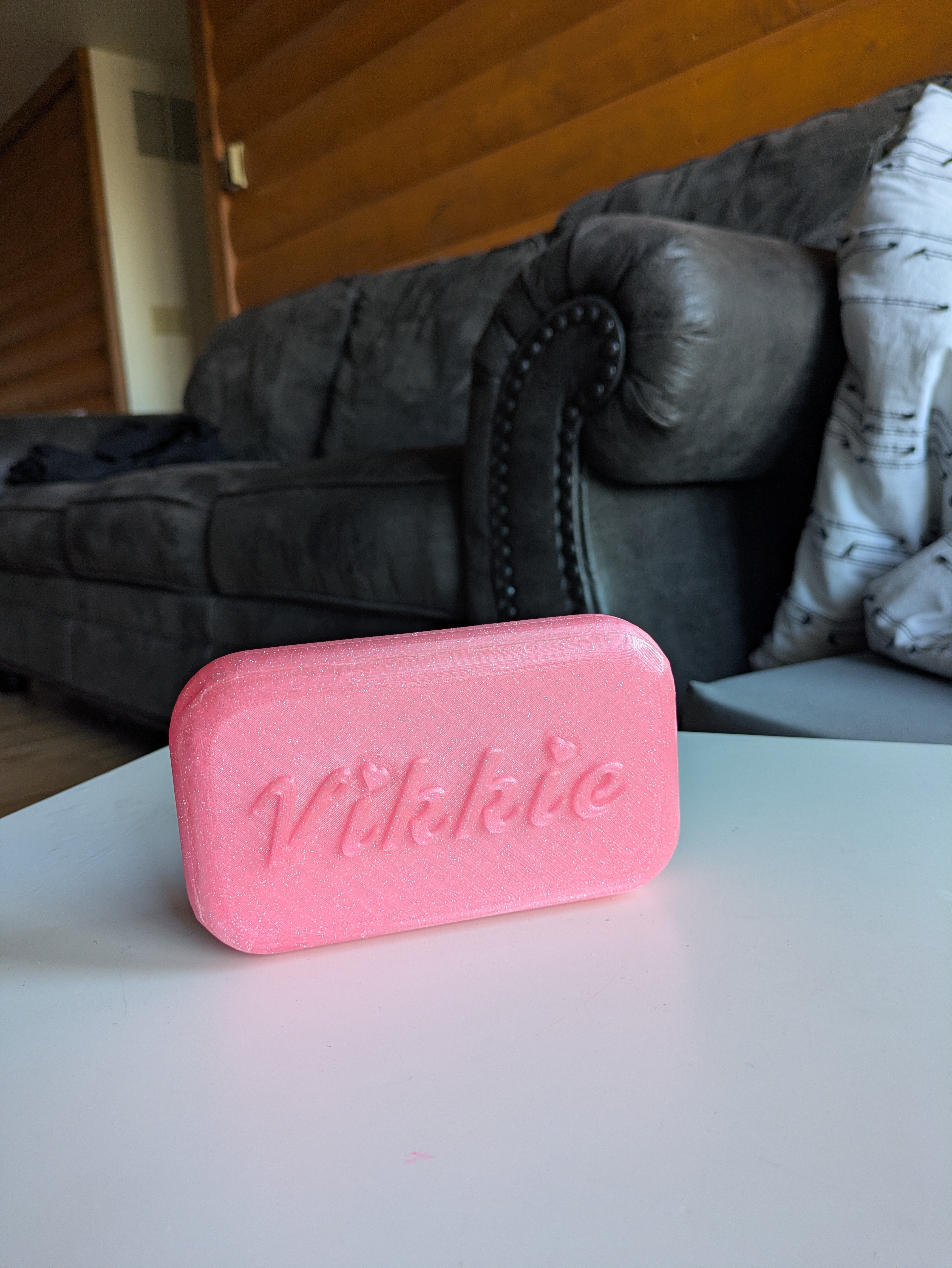 the back of the phone trinket box, with raised, barbie font that says vikkie