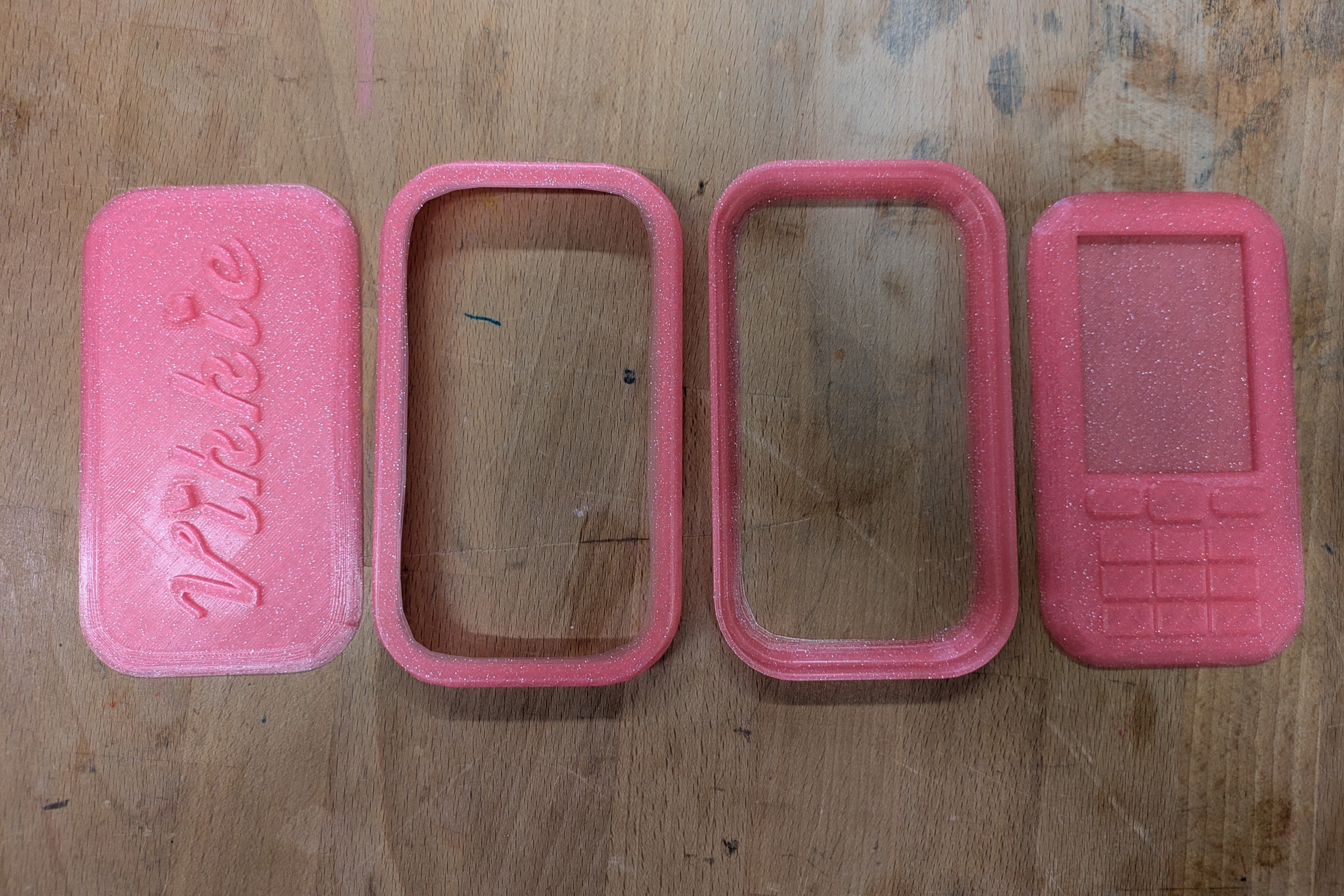 the four parts of the final 3d print before they're glued together